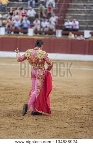 Andujar Spain - September 10 2011: The Spanish Bullfighter David Valiente bullfighting with the crutch in the Bullring of Andujar Spain