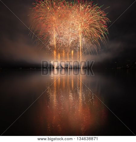 Colorful Fireworks With Reflection On Lake.