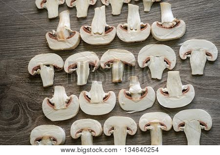 Cut white champignons settled into geometrical patterns