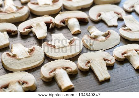Cut white champignons settled into geometrical patterns