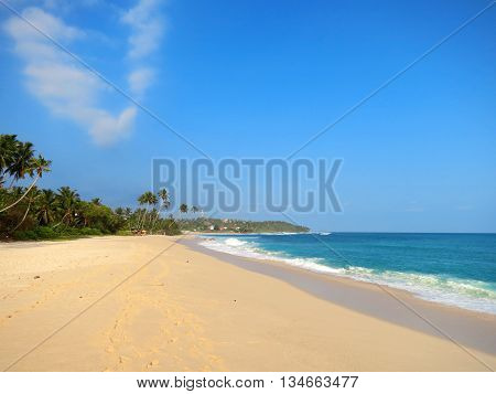 Empty wide clean beach with palms, Kamburugamuwa, Mirissa, Sri Lanka