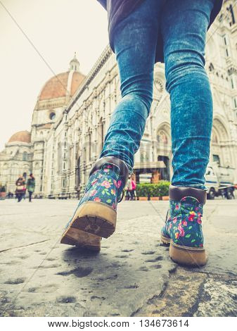 florence italy woman legs in jeans walking near the Santa Maria del Fiore cathedral in the square duommo