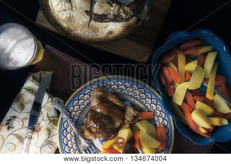 Rabbit pie with a side of root vegetables and gravy.