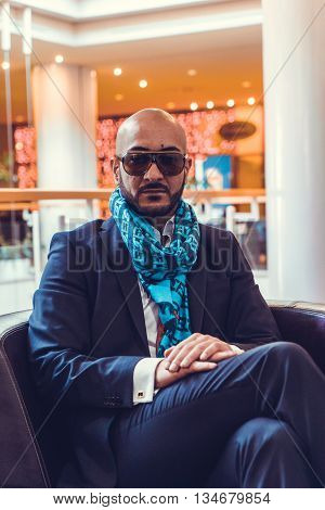 Arab businessman sitting on a sofa in an expensive hotel