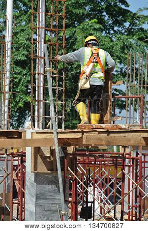 MALACCA, MALAYSIA -MARCH 13, 2016: Construction workers at the construction site in Malaysia. All of them is required to wear adequate safety equipment during works to make sure their safety.