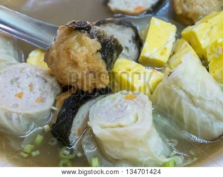 The close up of Taiwanese oden meat balls in soup at food street night market in Taipei, Taiwan.