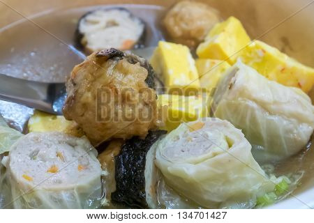 The close up of Taiwanese oden meat balls in soup at food street night market in Taipei, Taiwan.