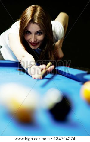 Young brunette girl playing snooker