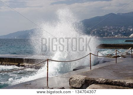 Sea surf wave closeup break on stone