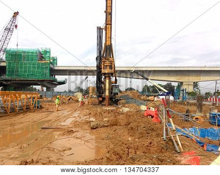 MALACCA, MALAYSIA - MARCH 12, 2015: Bore pile rig machine at the construction site in Malacca, Malaysia. The machine used to driven pile for building foundation work.
