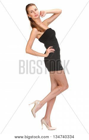 Elegant young woman in short little dress looking at camera. Isolated on white background.