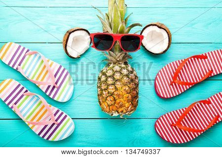 Summer time with accessories and fruits on blue wooden floor. Top view and selective focus