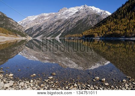 Beautiful reflection in lake Livigno in the Italian Alps