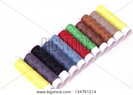 Colored sewing threads isolate on white background -select focus