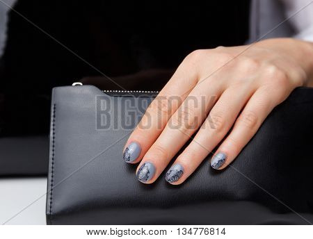 Closeup of elegant painted nails with lace motives
