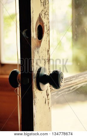 Old door know on a vintage door that needs paint.