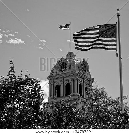 An American flag flies atop the Crook County Courthouse in Prineville, Oregon while a second one rises up from the courtyard.