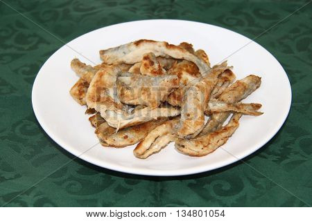 fried smelts Baltic fish on a dish on the tablecloth