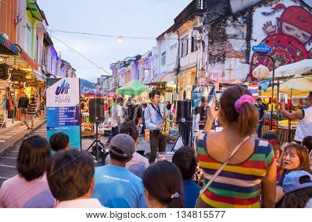 PHUKET THAILAND MAY 29 2016: Musician play saxophone jazz at night market of Phuket on May 29 2016.among old building Chino Portuguese style street of Phuket town is the famous popular