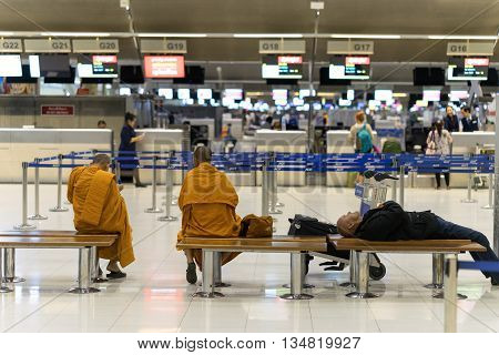 Bangkok, Thailand - march 1, 2016: Monks and businessman waiting fly in night quiet airport terminal