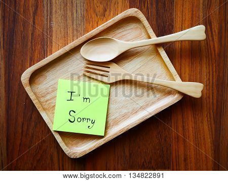 I'm sorry note with wooden plate in morning on top view