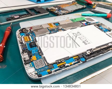 Repairing Tablet and Smart Phone on Desk Selective Focus