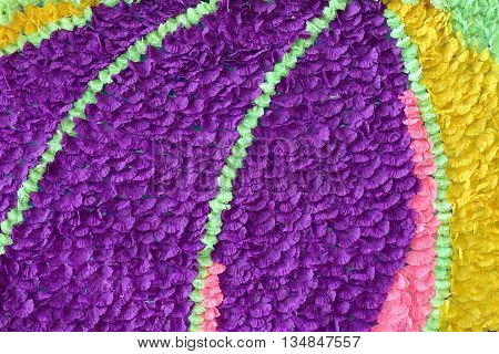 Background of colorful fake flowers that decorated the backdrop.