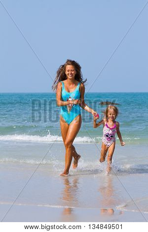 Mum with daughter on the beach in Thailand