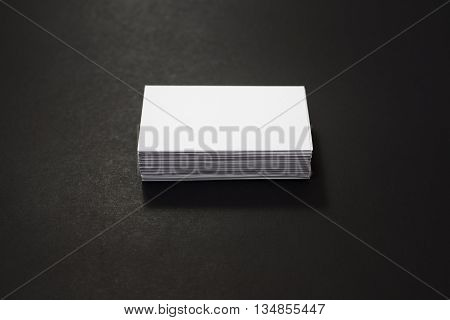blank business cards stack up on Black background