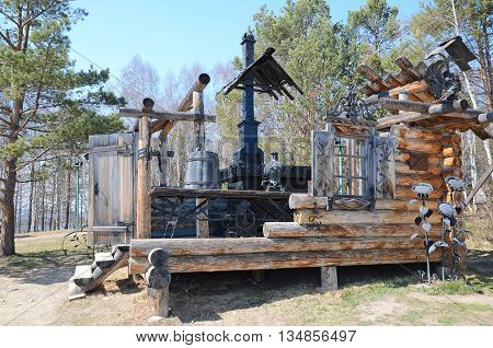 Irkutsk region Russia - May10 2015: The sculpture composition of schematic internal and external decoration of Russian hut