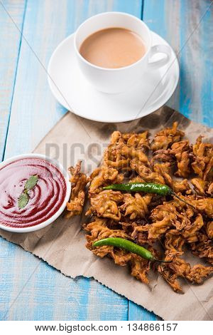 Samosa snack with tomato ketchup and hot tea, Fresh samosas with ketchup and hot chai ready for breakfast