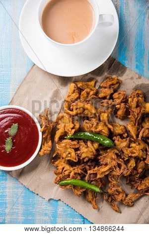 Samosa snack with tomato ketchup and hot tea, Fresh samosas with ketchup and hot chai ready for breakfast