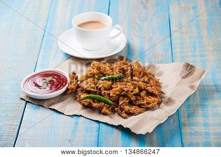 Samosa snack with tomato ketchup and hot tea, Fresh samosas with ketchup and hot chai ready for breakfast