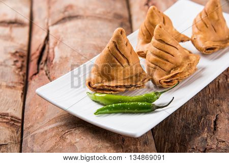 Samosa snack with tomato ketchup and hot tea, Fresh samosas with ketchup and hot chai ready for breakfast
