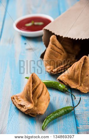 Samosa snack with tomato ketchup and hot tea, Fresh samosas with ketchup and hot chai ready for breakfast