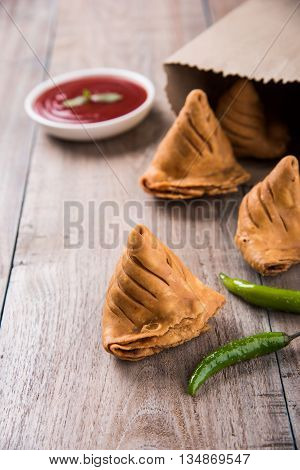 Samosa snack with tomato ketchup and hot tea, Fresh samosas with ketchup and hot chai ready for breakfast