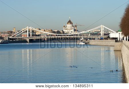 View from Moskva-river on Crimean bridge and Christ the Savior Cathedral in Moscow under clear blue sky