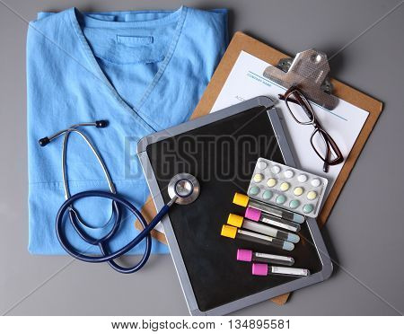 Doctor in blue uniform holding X-rays. clinic