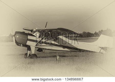 Old sports plane at the airport flying club. Stylized black and white photograph