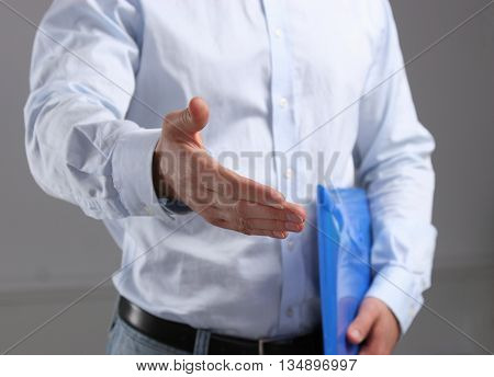 Business man offering his hand for handshake.