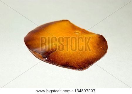 Pendant made of dried rose petal inside the epoxy resin close-up