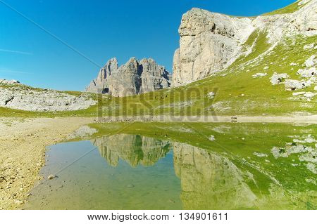 Lake in the Dolomites, trekkers along the shore