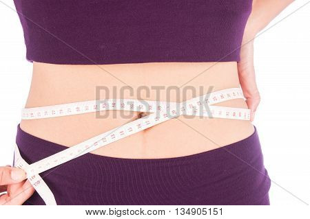Slim waist beauty women with a tape measure her shape