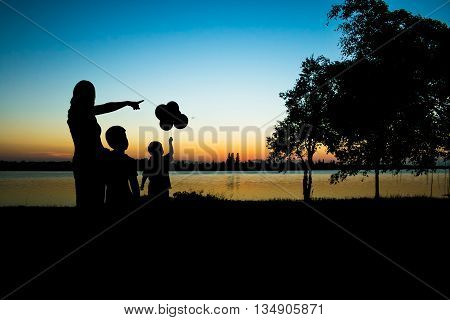 Silhouette Mother and son looking on natural sunset