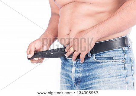 Young fat man try wearing a belt