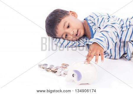 cute asian boy saving money in piggy bank