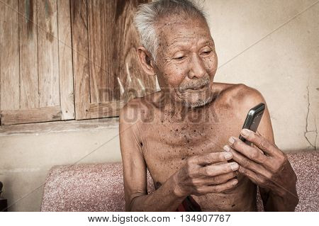 portrait of elder man use telephone, vintage tone