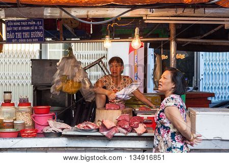 HO CHI MINH CITY VIETNAM - FEBRUARY 07: Women are selling meat at the wet market on February 07 2016 in Ho Chi Minh City Vietnam.