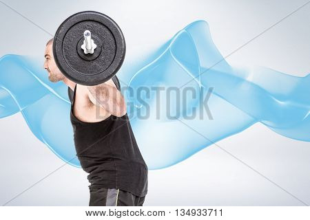 Bodybuilder lifting heavy barbell weights against grey background