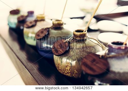 Aromatic oil in ceramic vase for traditional thai massage